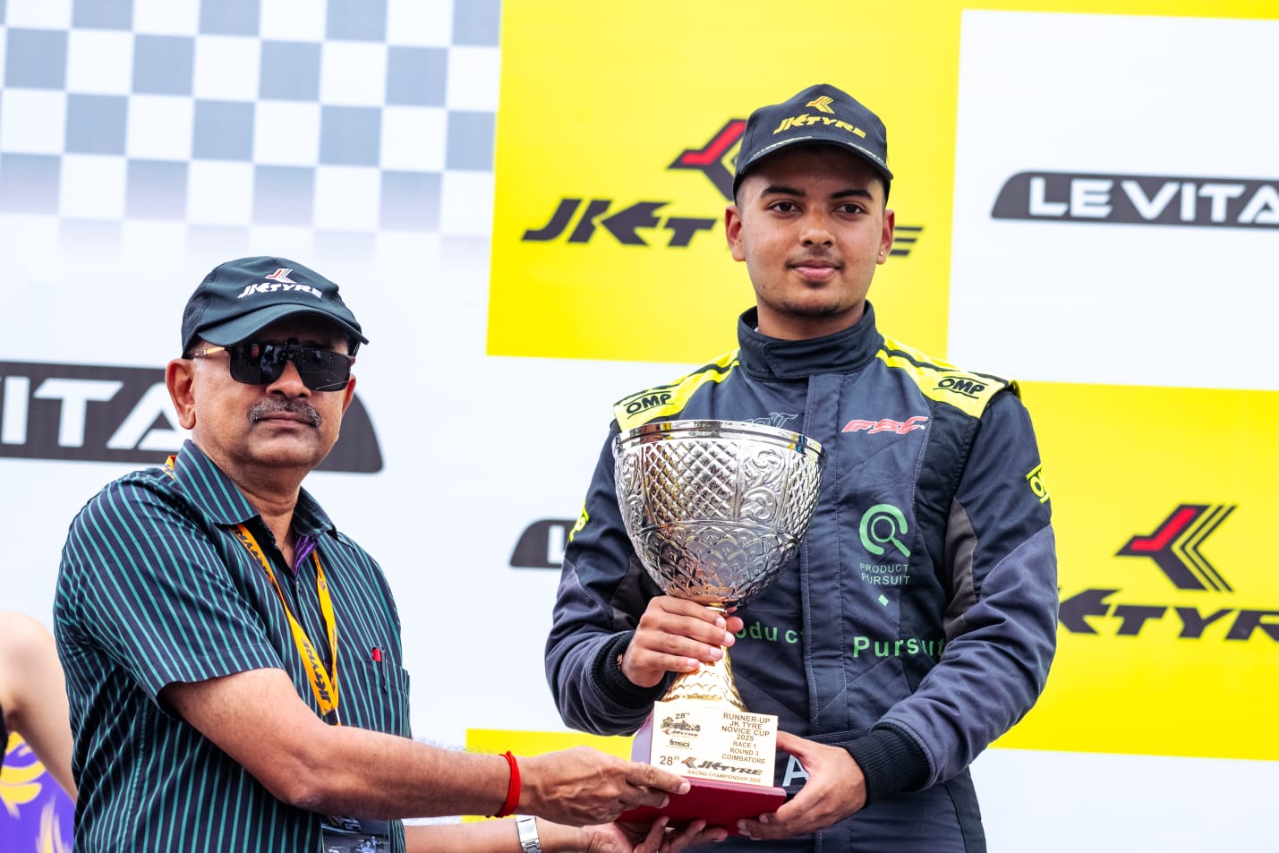 Avi Malavalli receiving a racing trophy